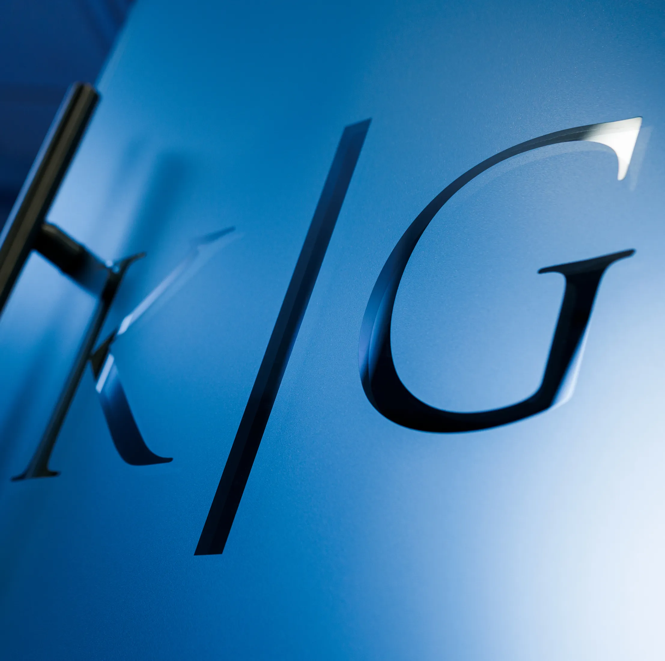 K G Glass door logo on the blue door