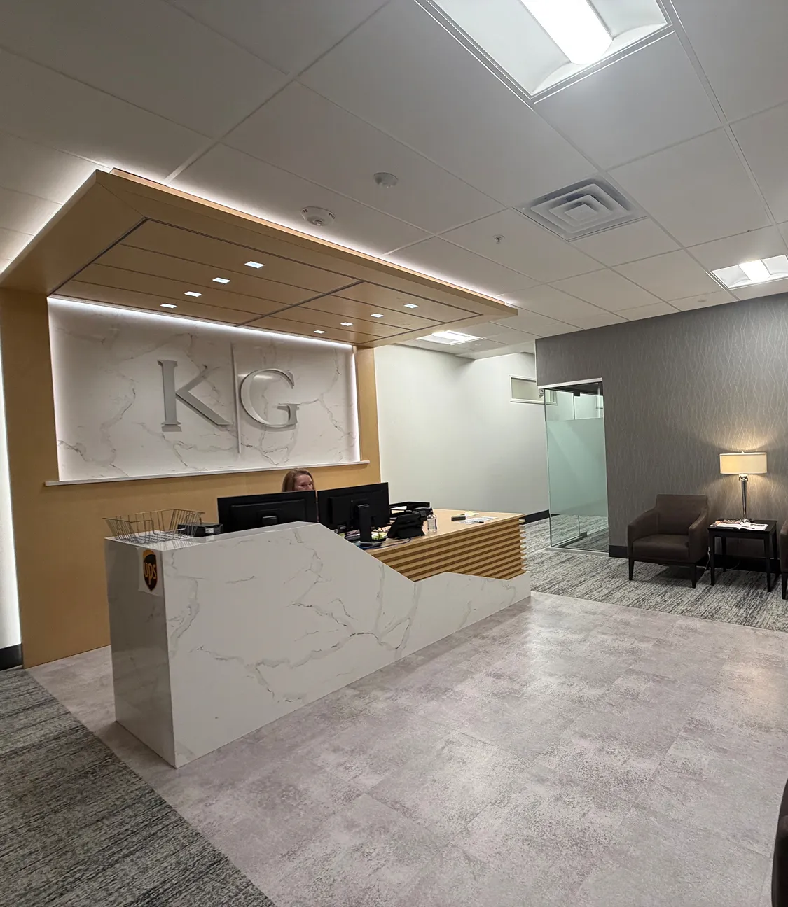 K & G logo with logo on brown wall on the left and glass door at the end mobile version K & G logo with logo on brown wall on the left and glass door at the end mobile version