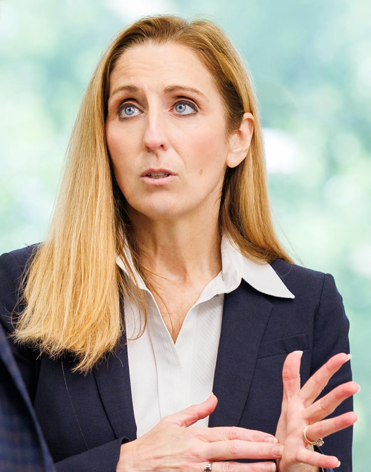 female blonde hair in suit talking to someone no visible with hands movement female blonde hair in suit talking to someone no visible with hands movement